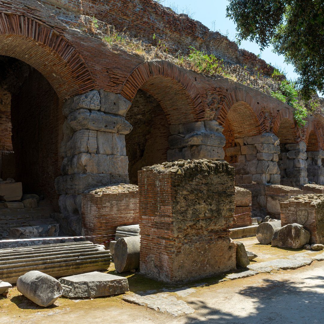 Archi radiali in laterizio e pietra dell'Anfiteatro Flavio di Pozzuoli con frammenti di colonne caduti a terra